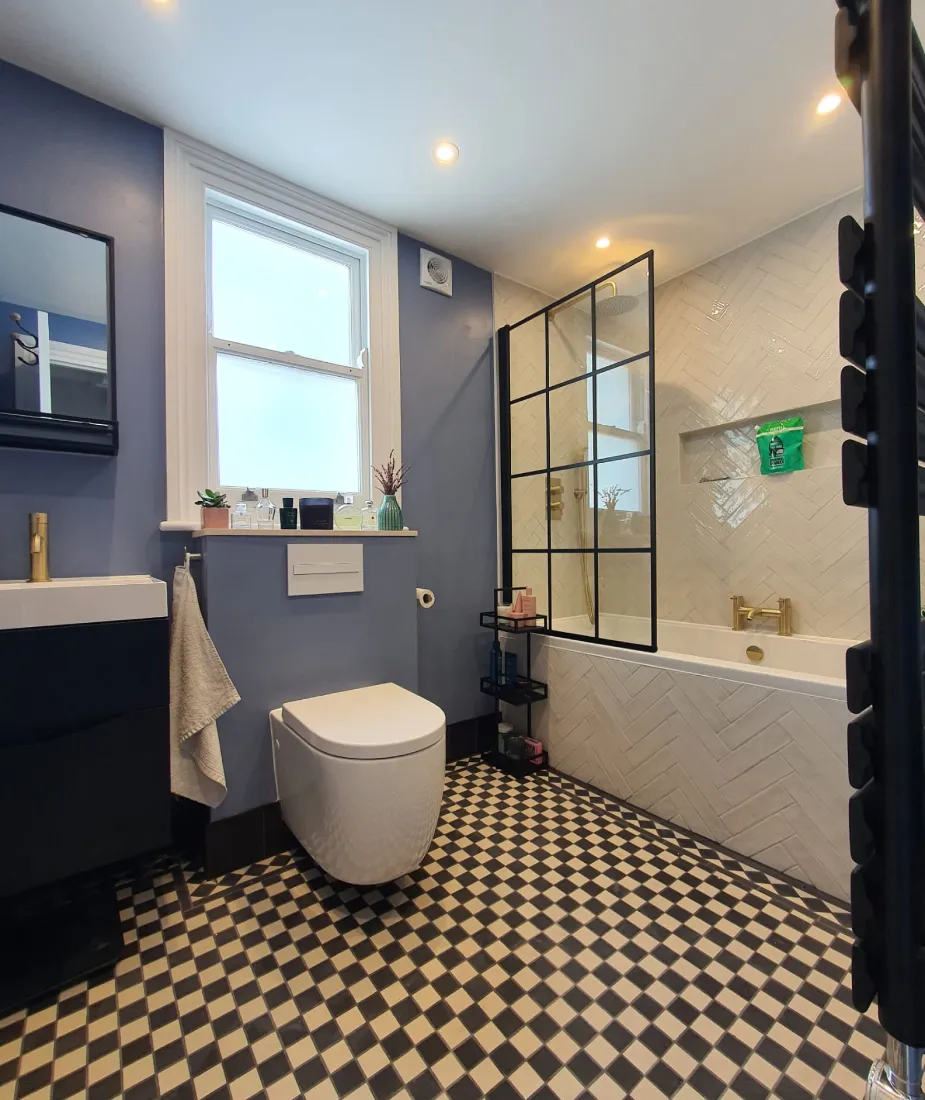 Finished bathroom with wall-hung toilet and checkerboard tiles