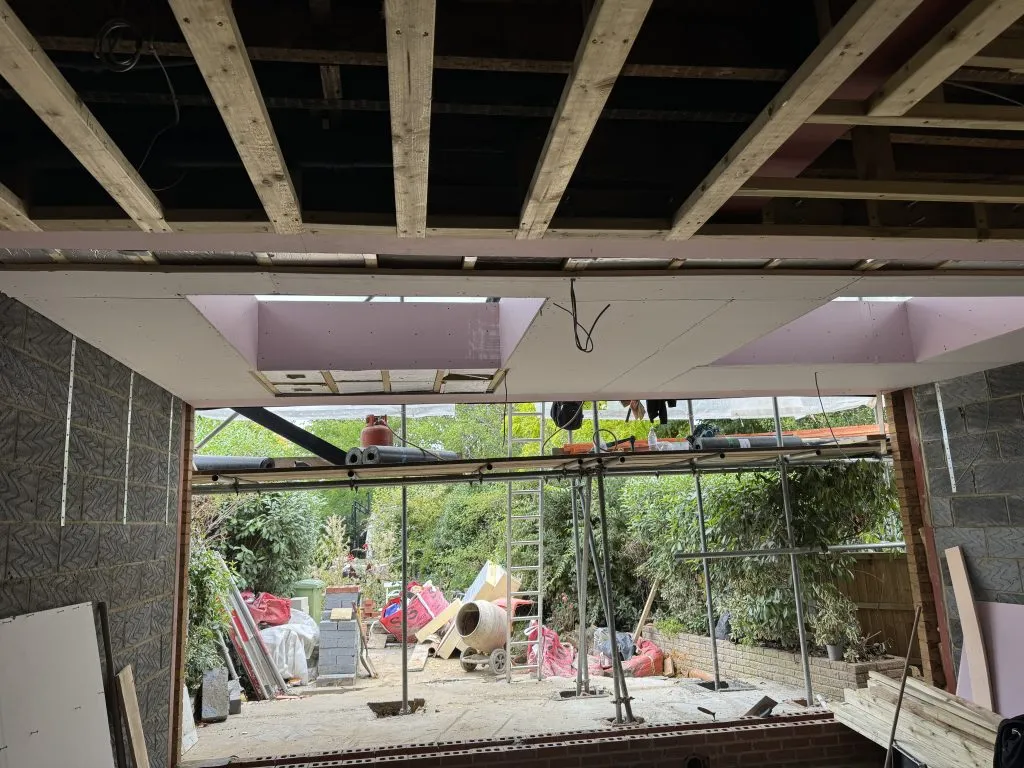 Rear extension under construction with roof joists and skylights