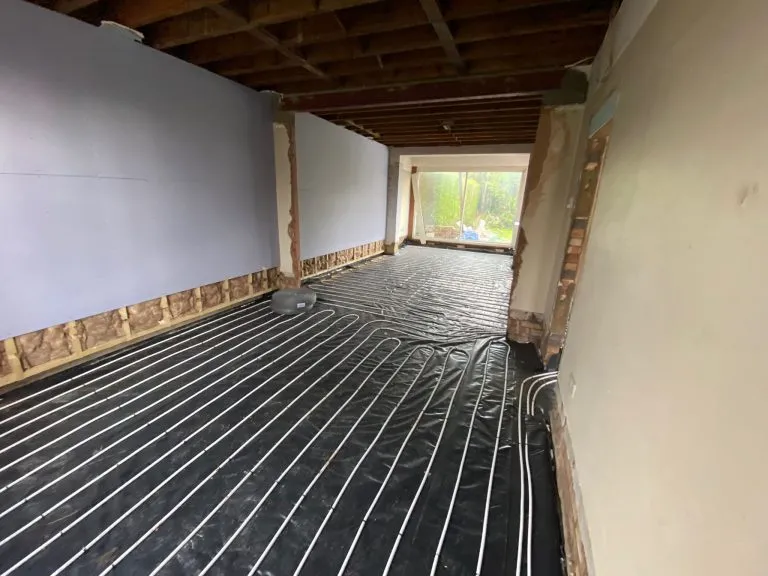 Underfloor heating pipes laid across an extension before the screed goes down